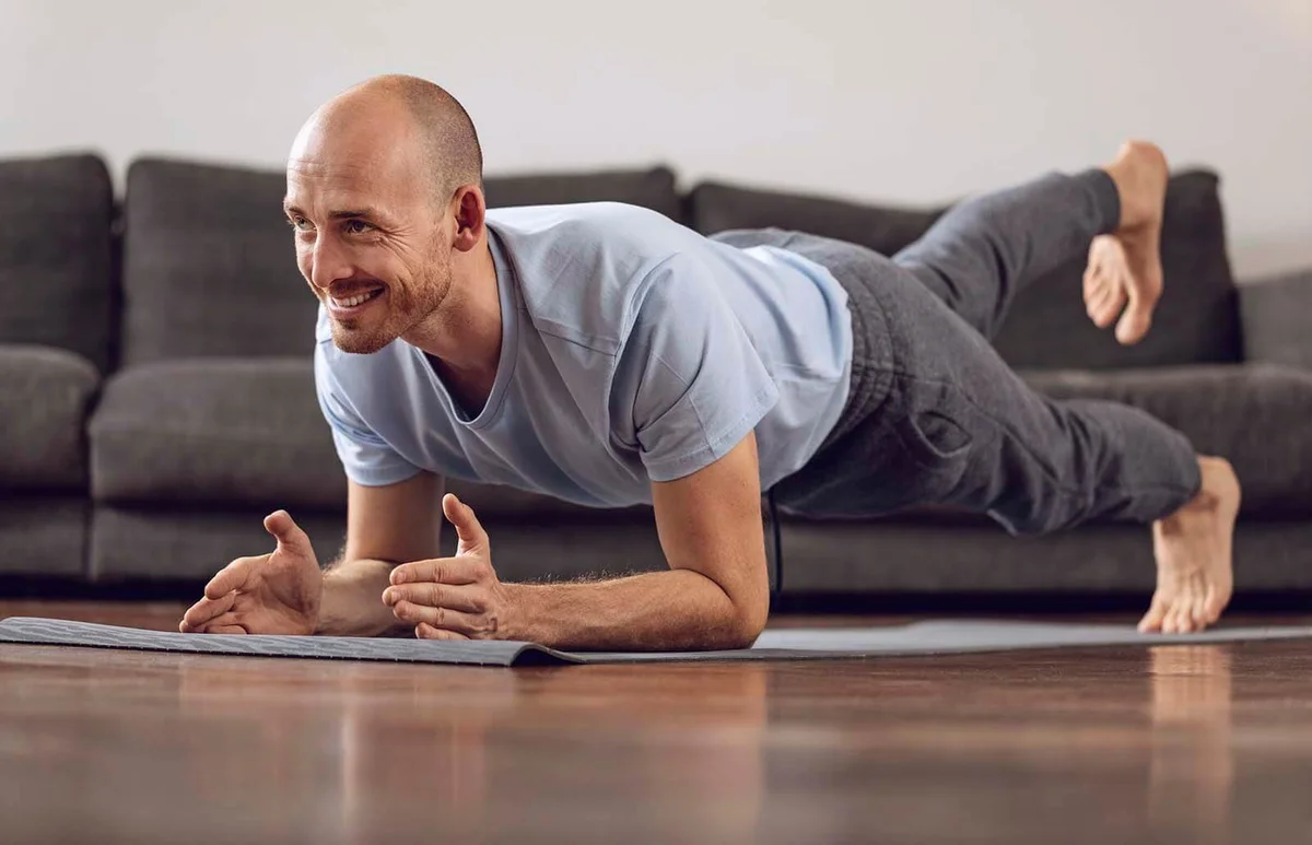 Man doing yoga at home