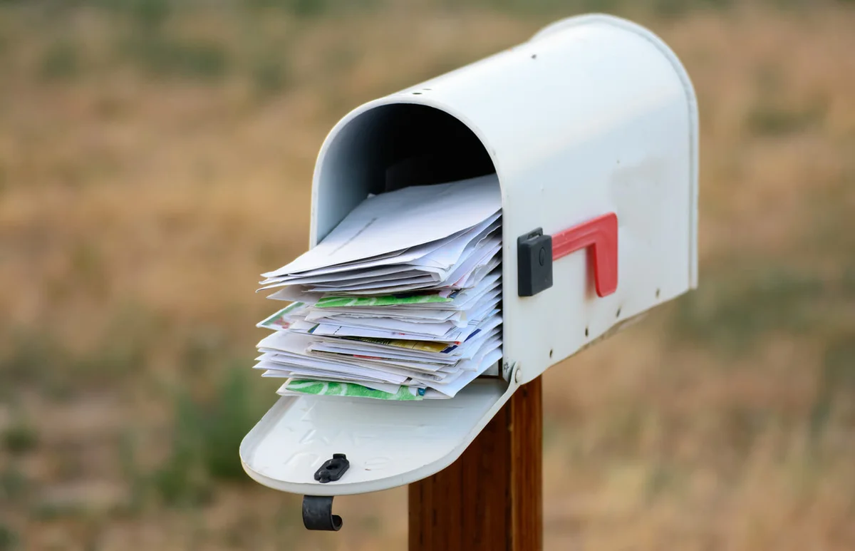 A mailbox overflows with mail