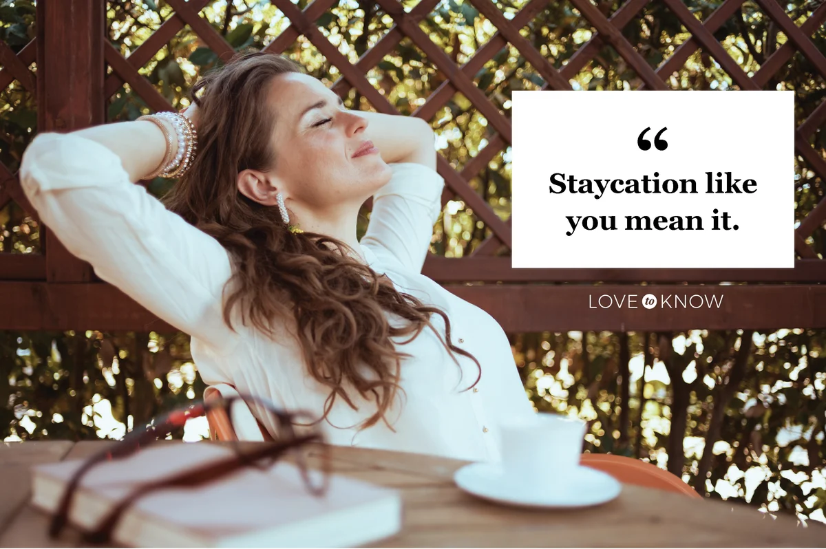 Relaxed woman sitting at table with a book and an expresso