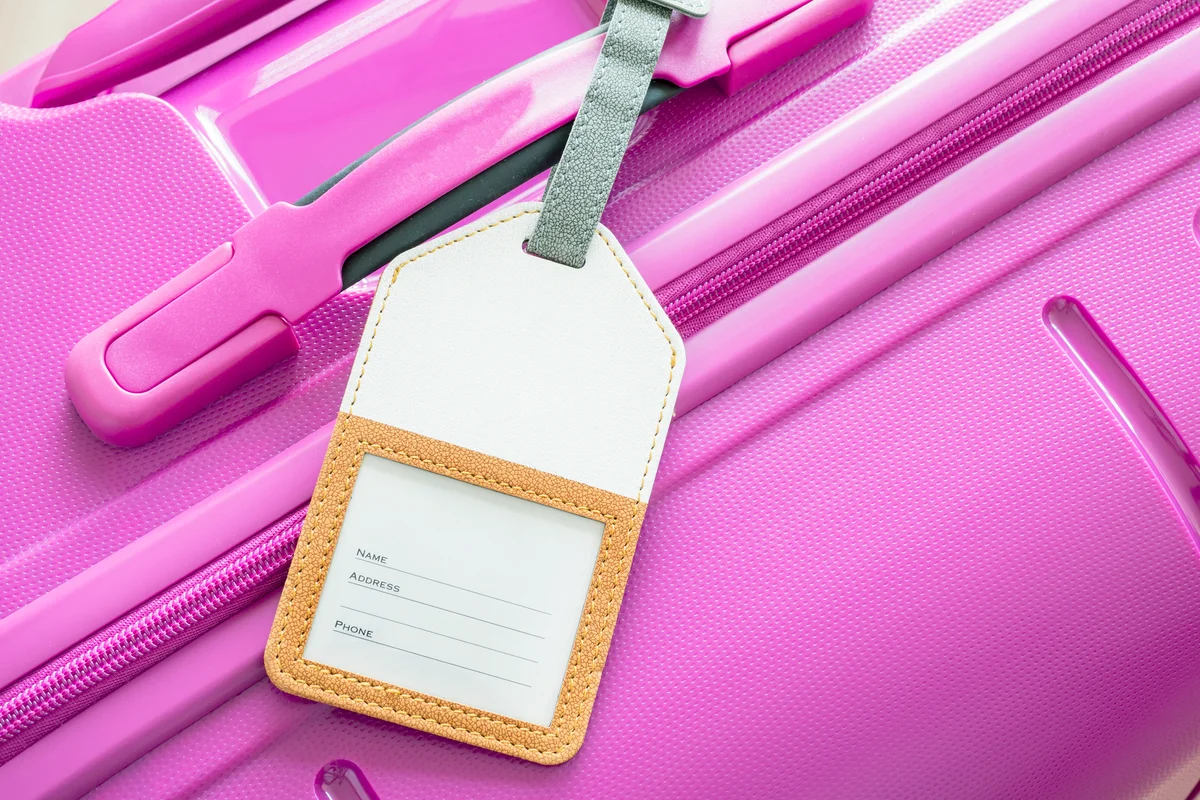 Luggage tag on pink suitcase