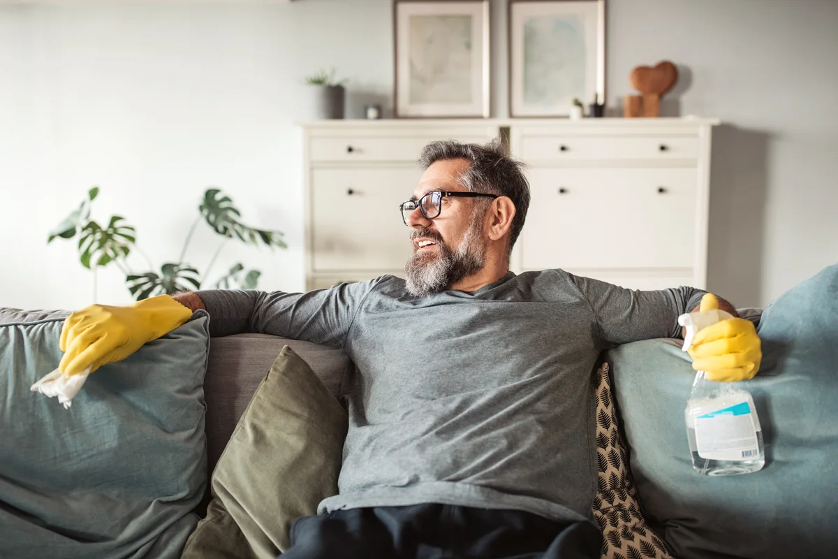 Men resting after cleaning couch