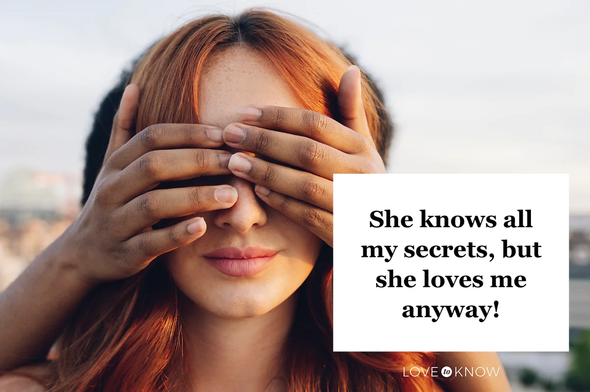 Woman covering eyes of redhead girlfriend with hands at sunset