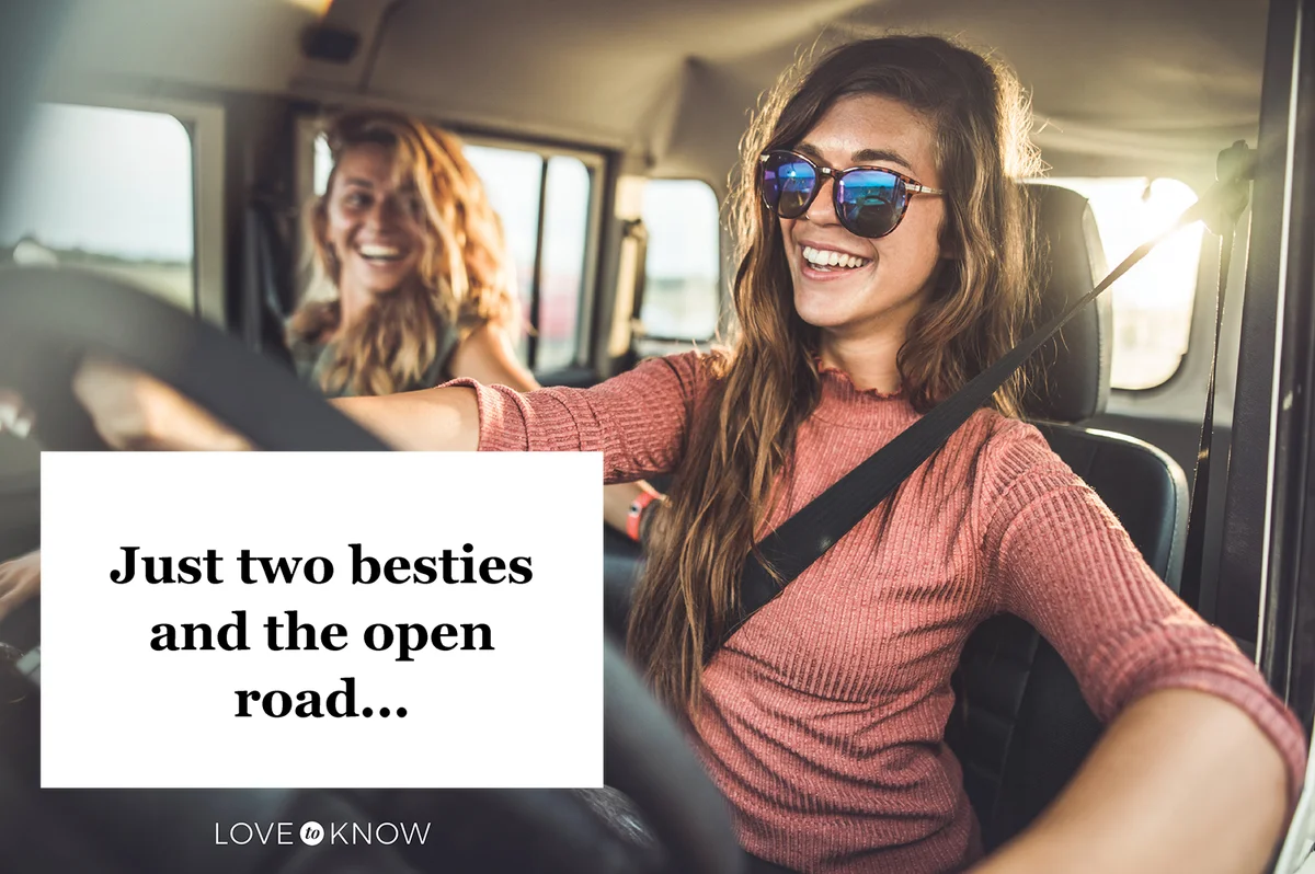 Happy female friends going on a road trip by car