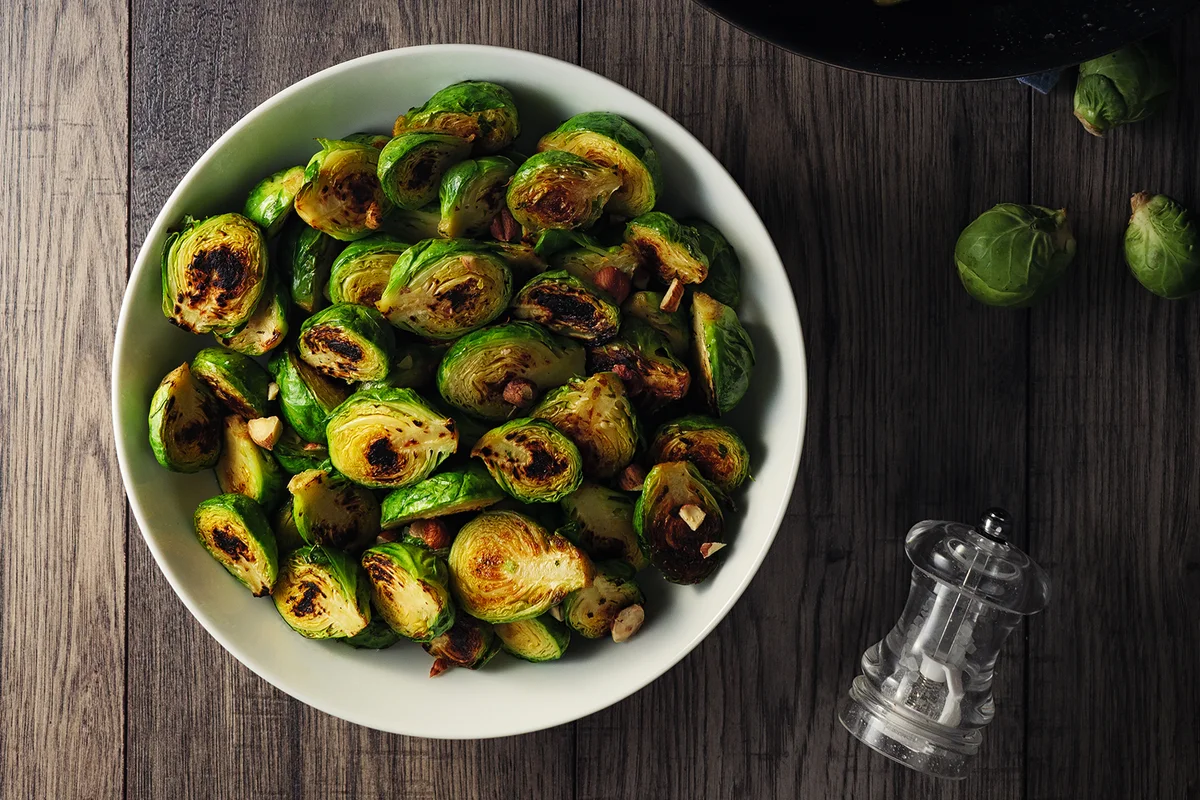 Charred sprouts with spicy herb butter and fine chopped hazelnuts