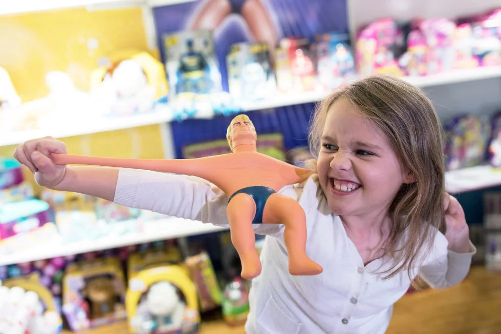 Girl plays with a 'Stretch Armstrong' toy