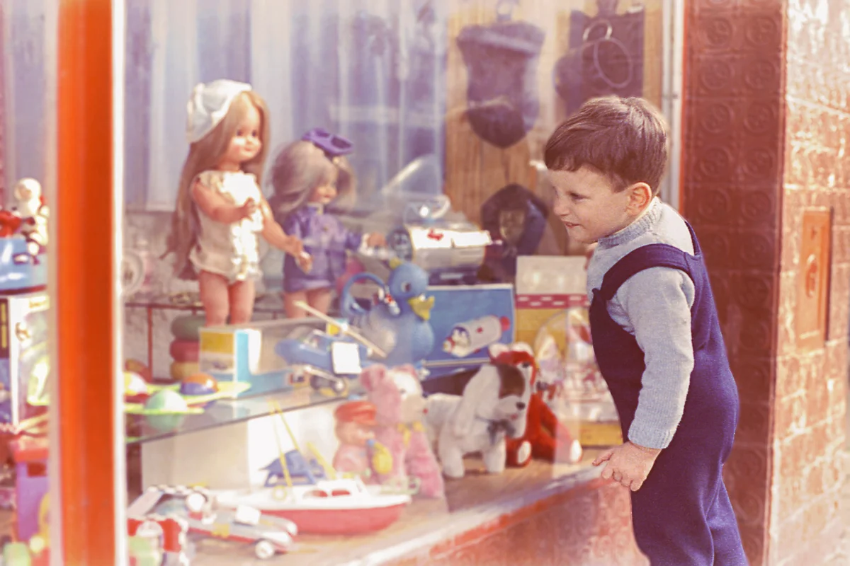 Vintage kid looking at a toy's shop