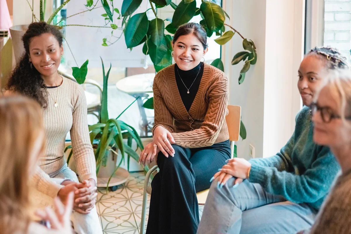 Multi-ethnic group of women sitting in a group therapy session