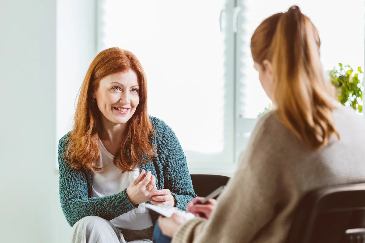 Smiling woman with therapist at community center