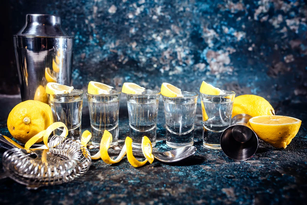 Silver tequila shots with lemon slices