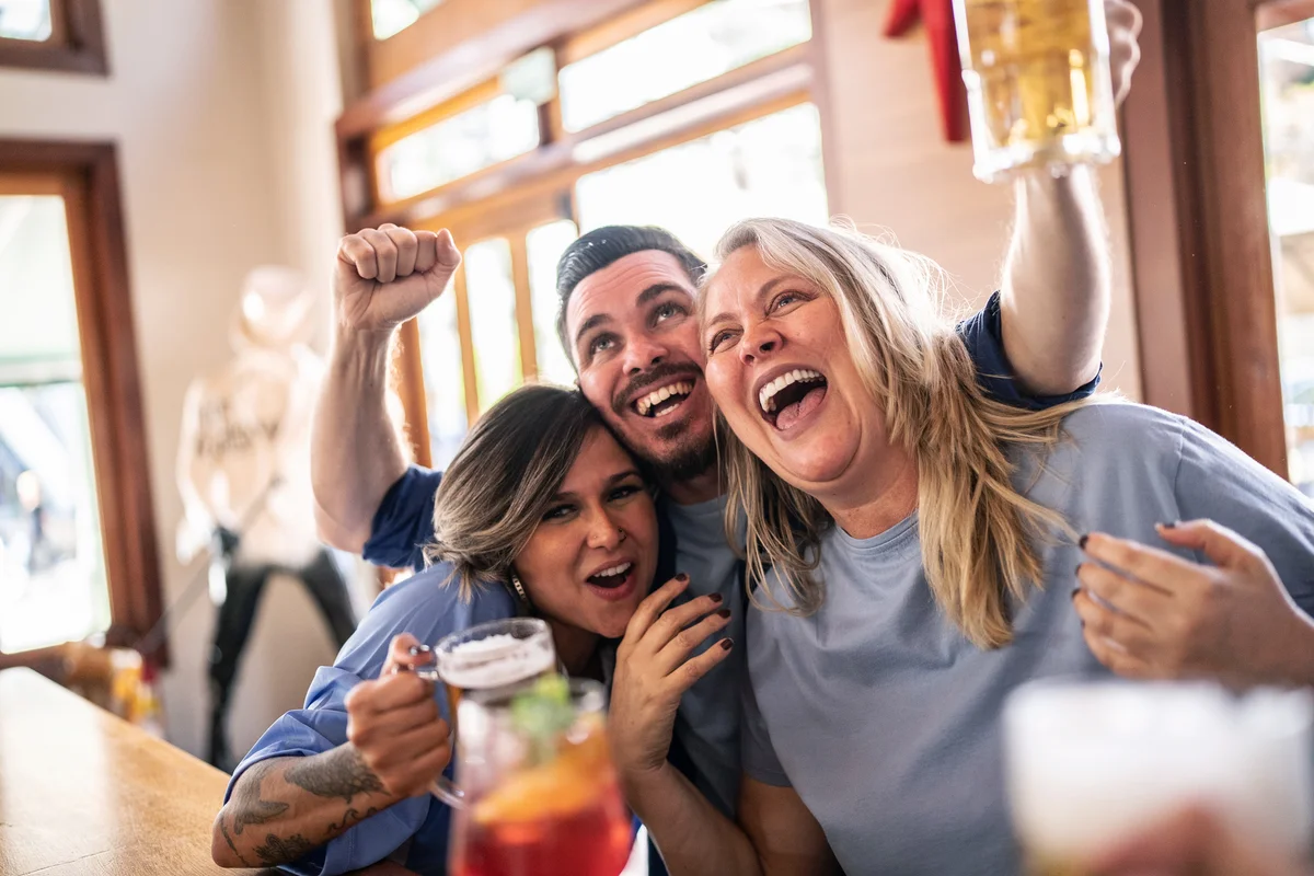 Football fans celebrating game while drinking