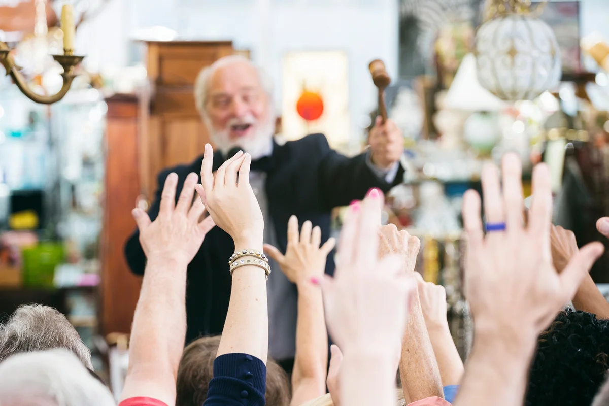 Auctioneer with Large Crowd of Buyers