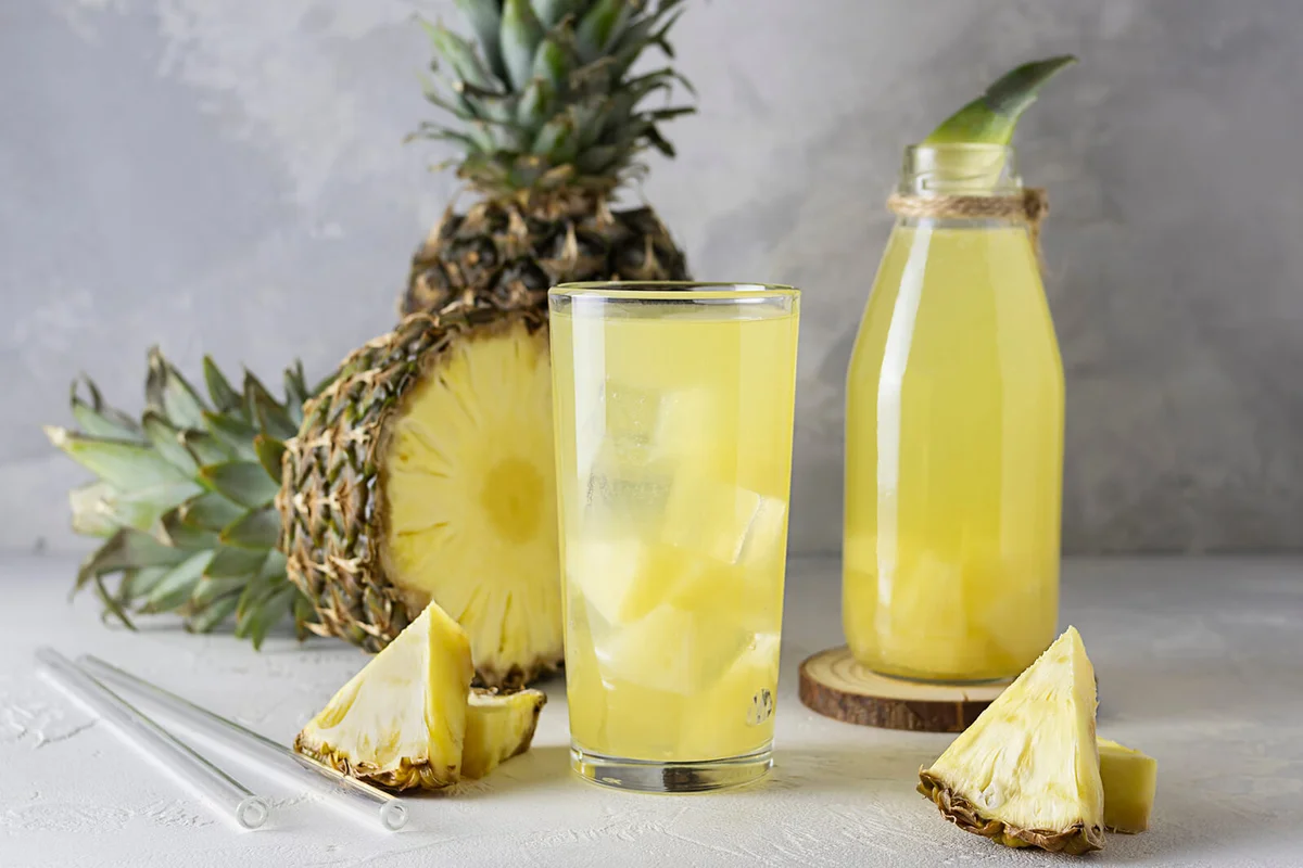 pineapple drink in a transparent glass on a bright table