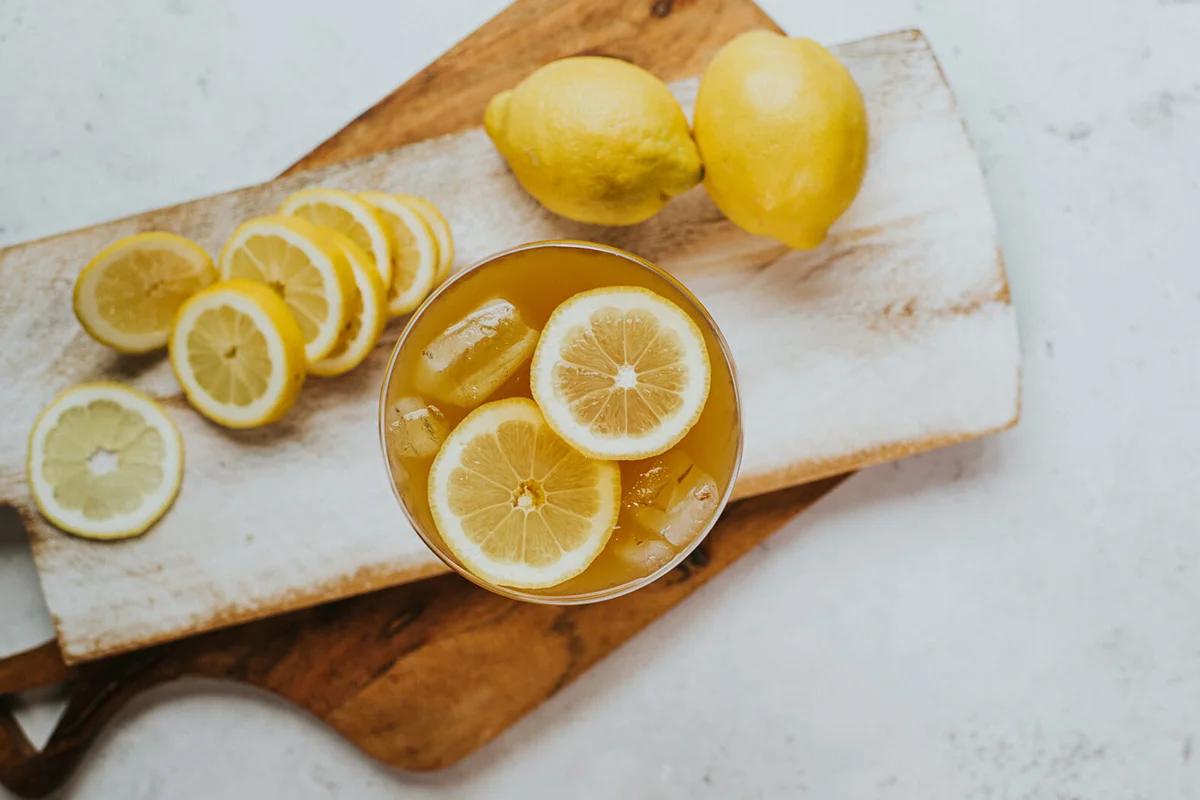 Fresh and delicious top down image of a drink garnished with lemon slices and ice