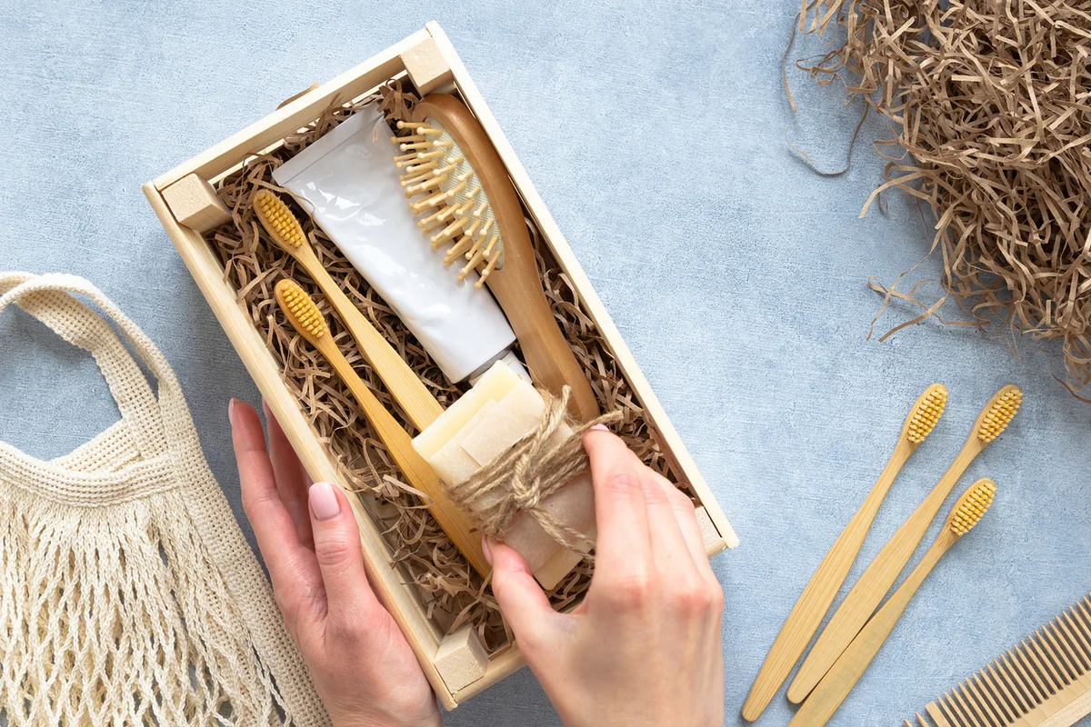Young woman preparing gift box set of natural eco friendly supplies for teeth
