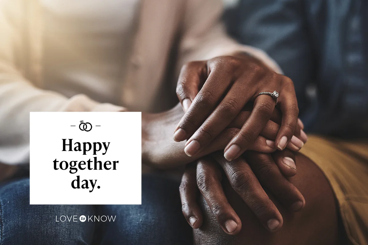 Man and woman sitting on a sofa and holding hands