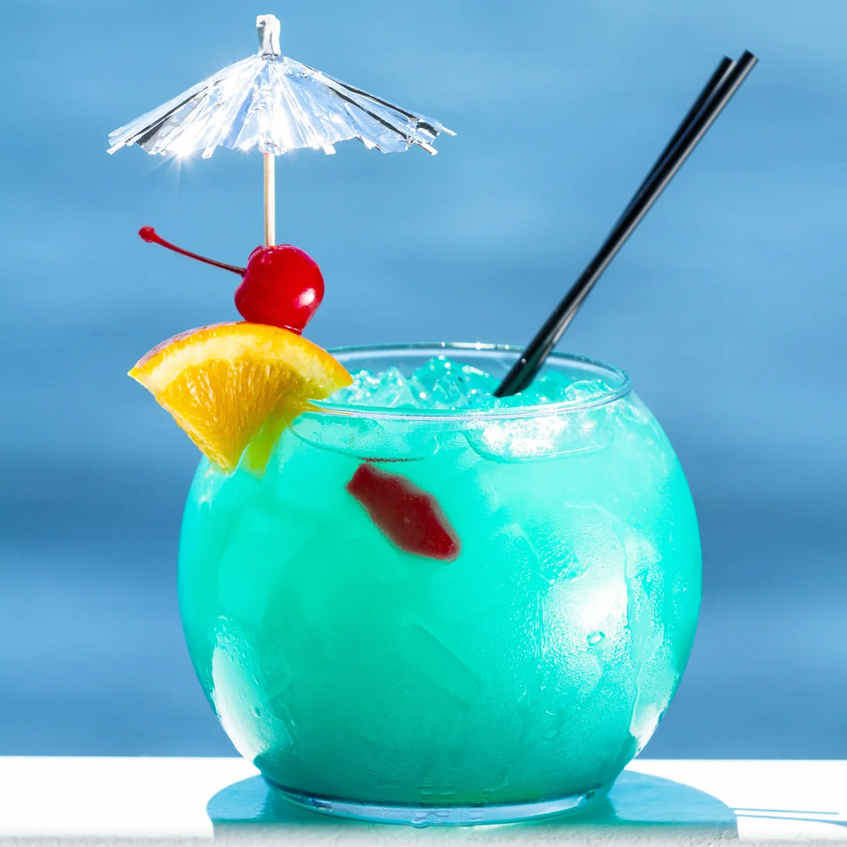 Blue cocktail served in a fish bowl