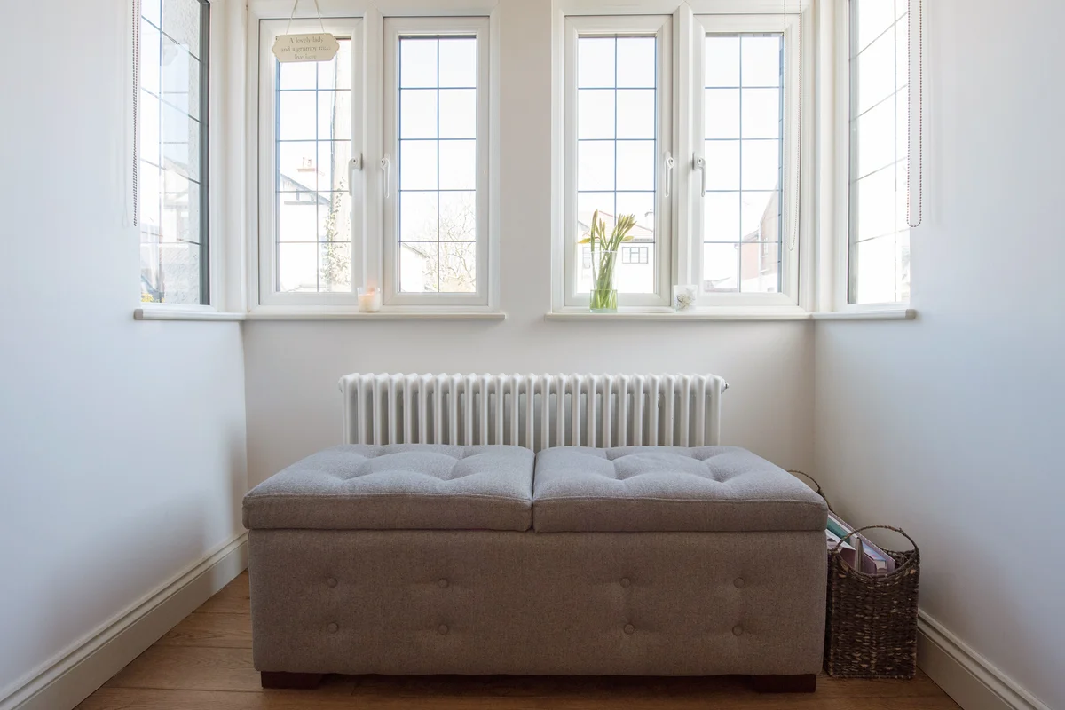 General interior view of an ottoman bench under a leaded window