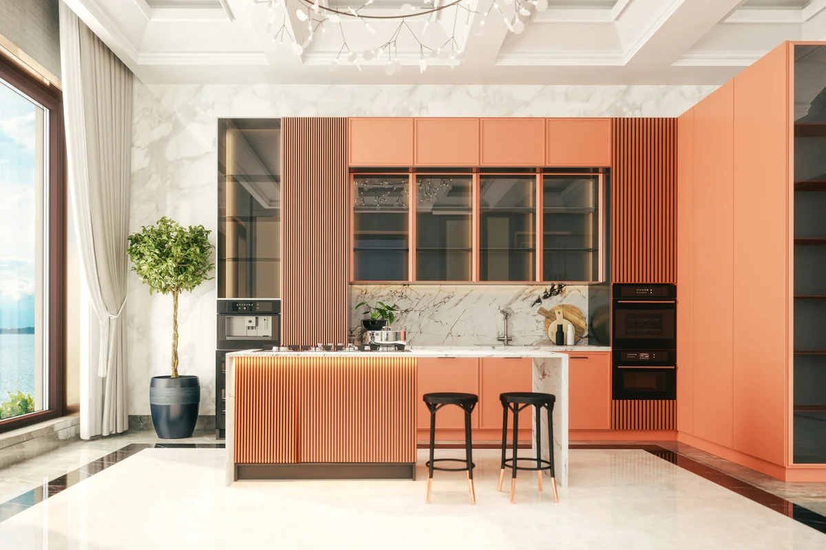 Interior of a retro styled luxury kitchen with coral cabinets