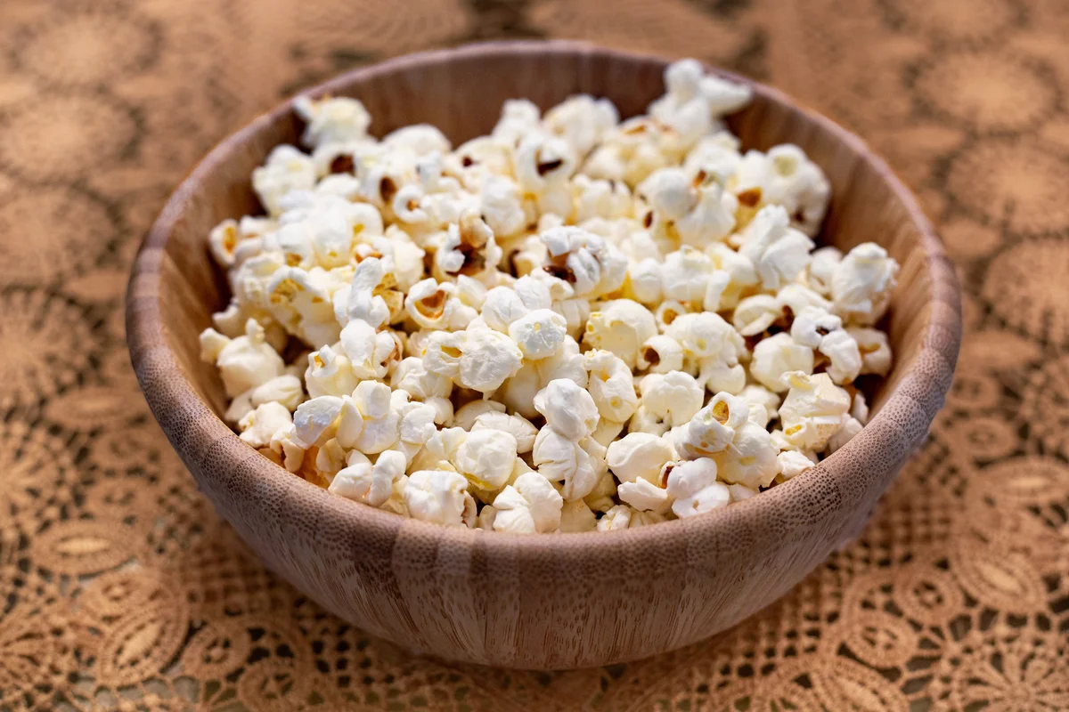Popcorn inside bamboo bowl.