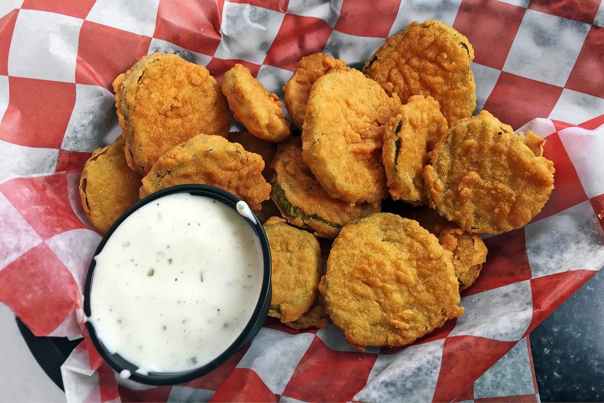 Fried pickles appetizer in a basket and ready to eat