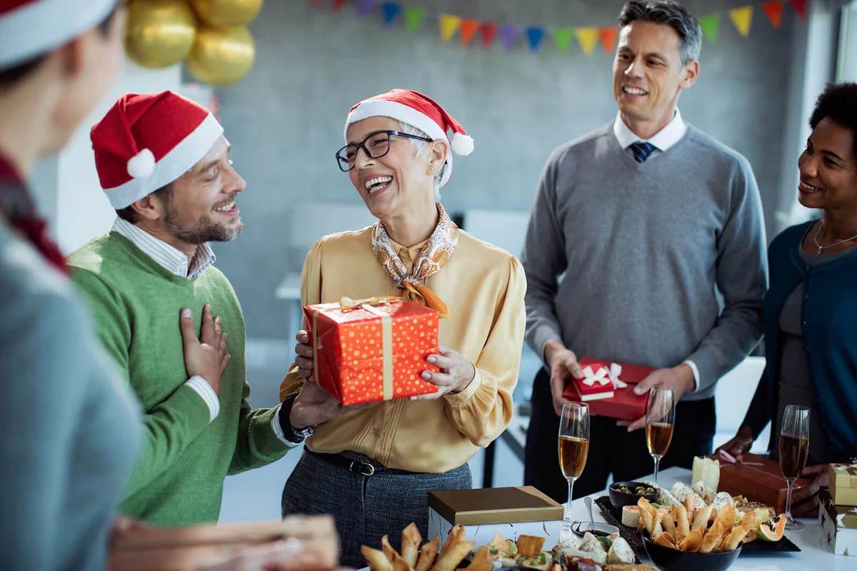 businesswoman receiving Christmas present on office party
