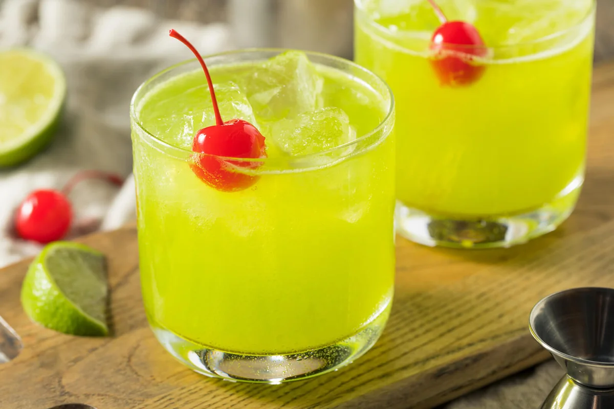 Homemade Green Melon Midori Sour with a Red Cherry