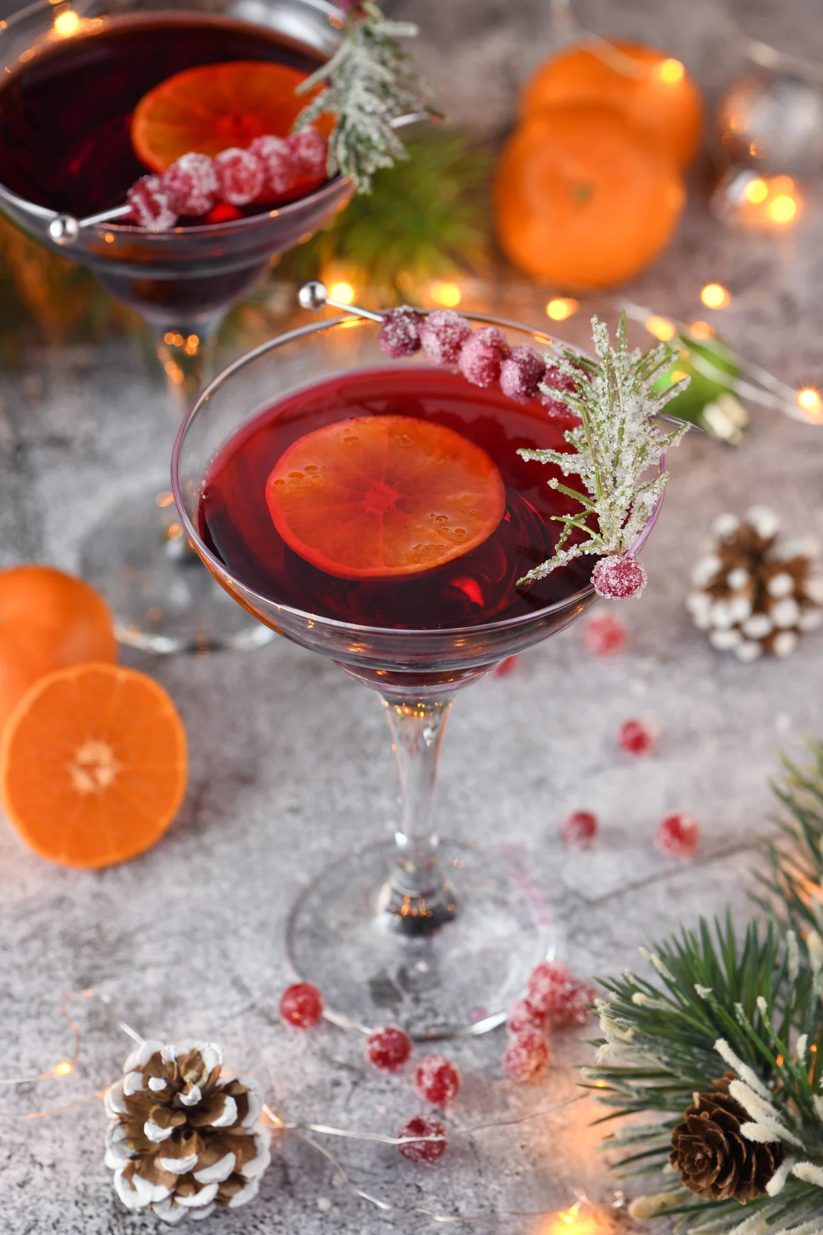 Cranberry cocktail with wine and christmas decorations on table