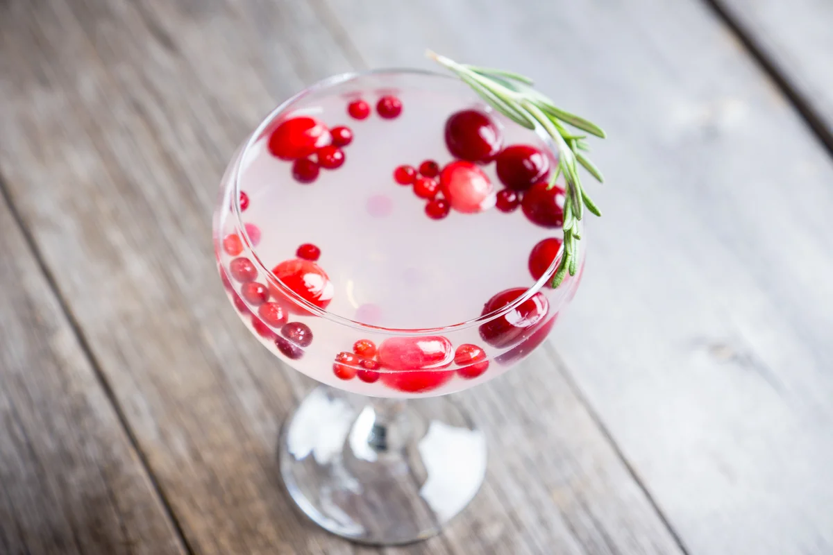 Tasty christmas cocktail with cranberry and rosemary