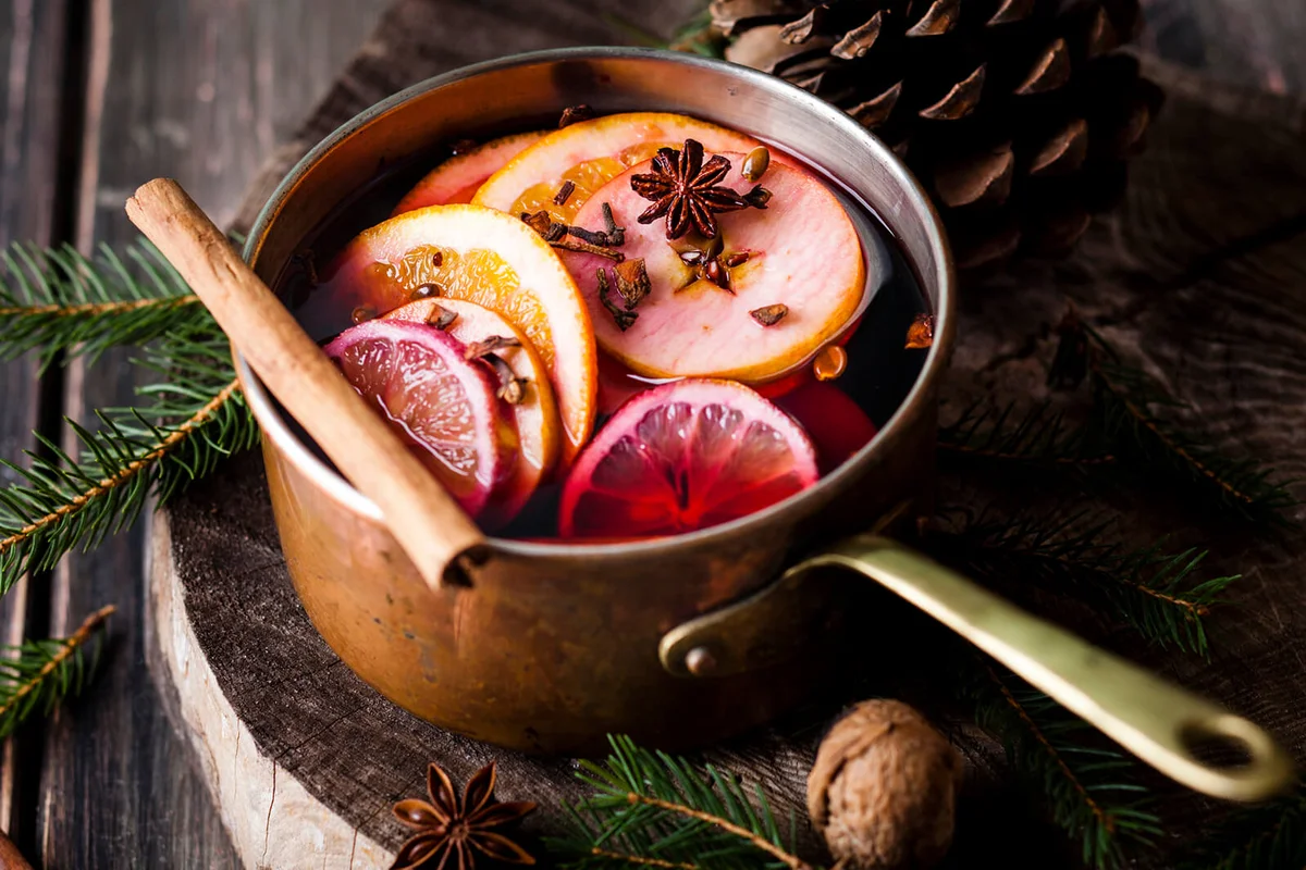 Mulled wine with oranges and cinnamon in a saucepan