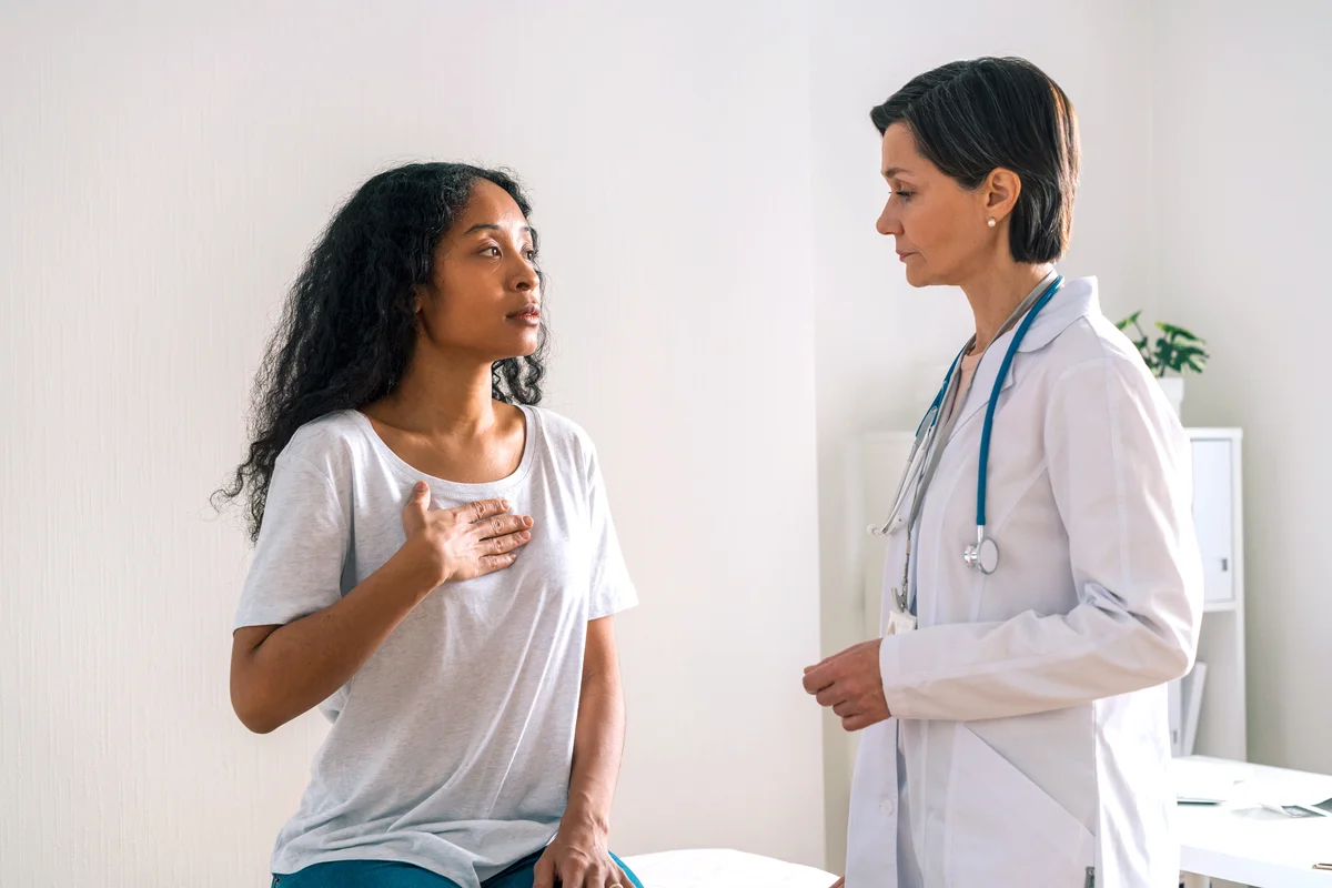 Female doctor carefully listening to complaints of patient