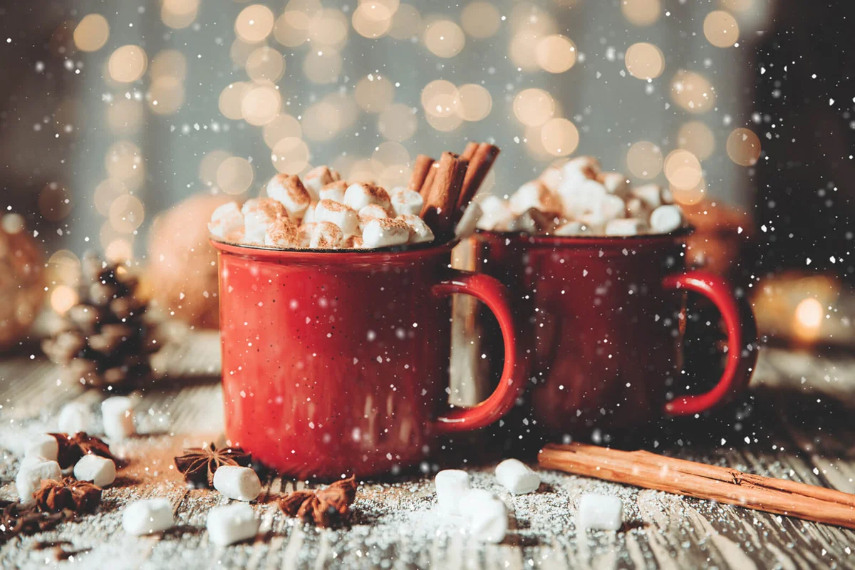 Two Cups of coffee with christmas decorations on dark wooden table