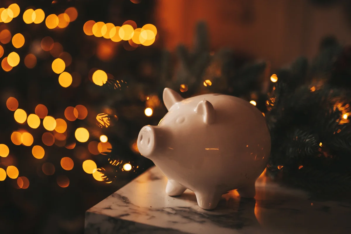 Piggy bank in festive Christmas atmosphere of scenery.