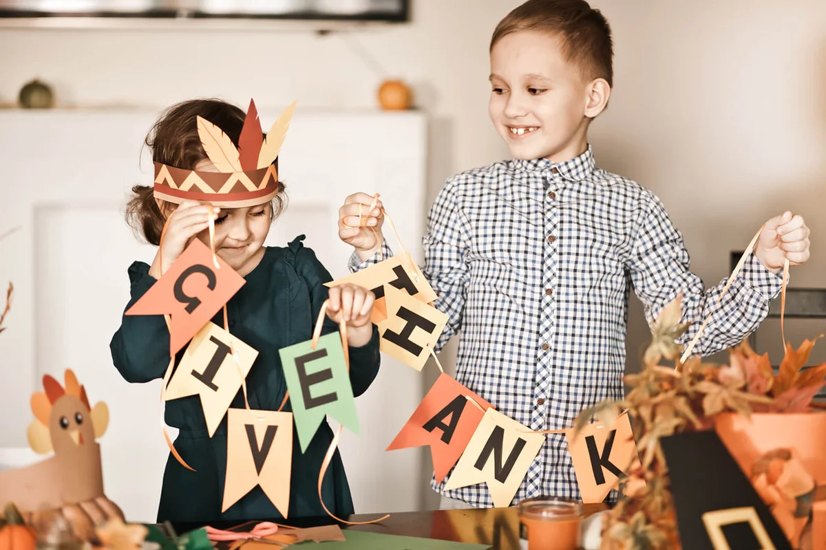Children decorating living room for celebrating Thanksgiving day