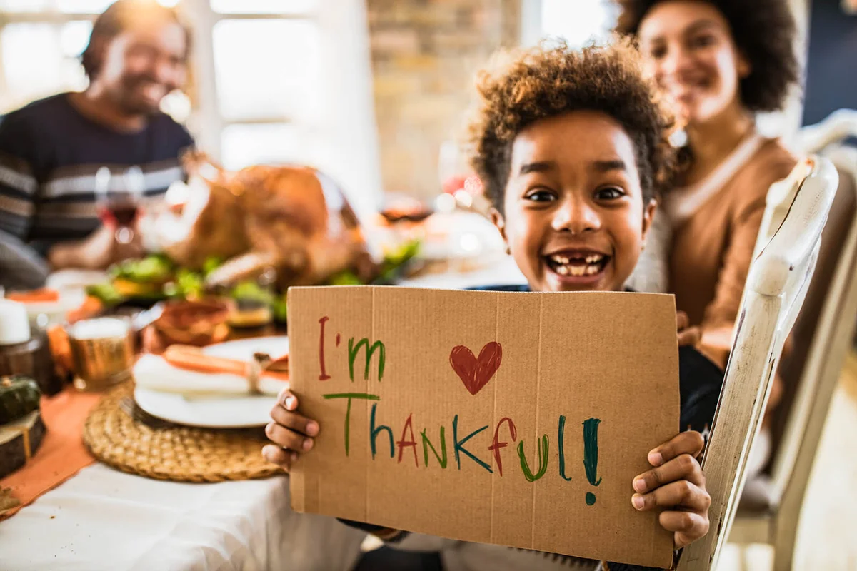 Happy girl holding 'I'm thankful' sign