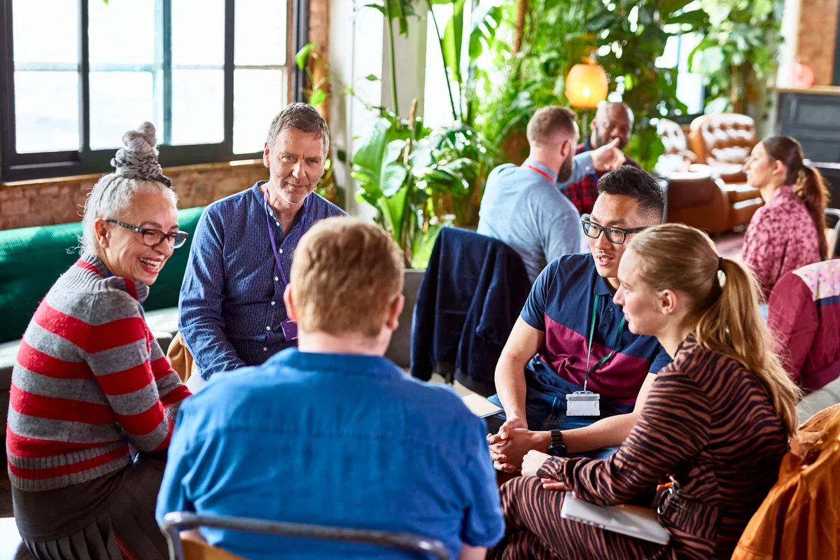 Diverse colleagues meeting in open office space for a stress workshop