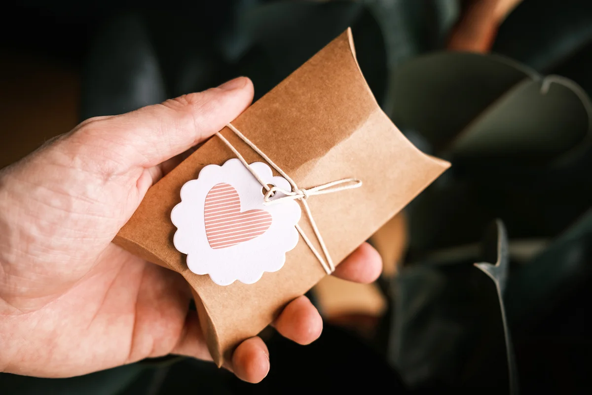 Male hands holding a small gift