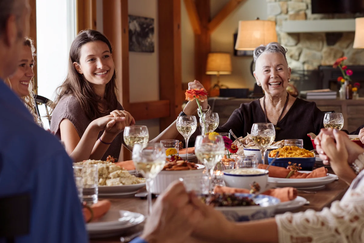 Happy family holding hands during Thanksgiving at home