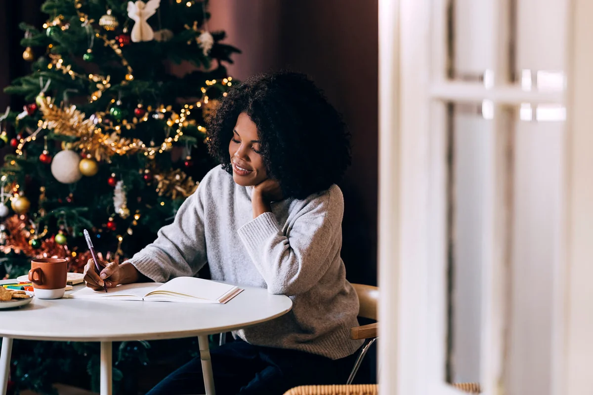Woman making Christmas card list