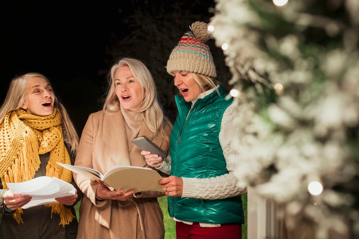 Three women Christmas caroling