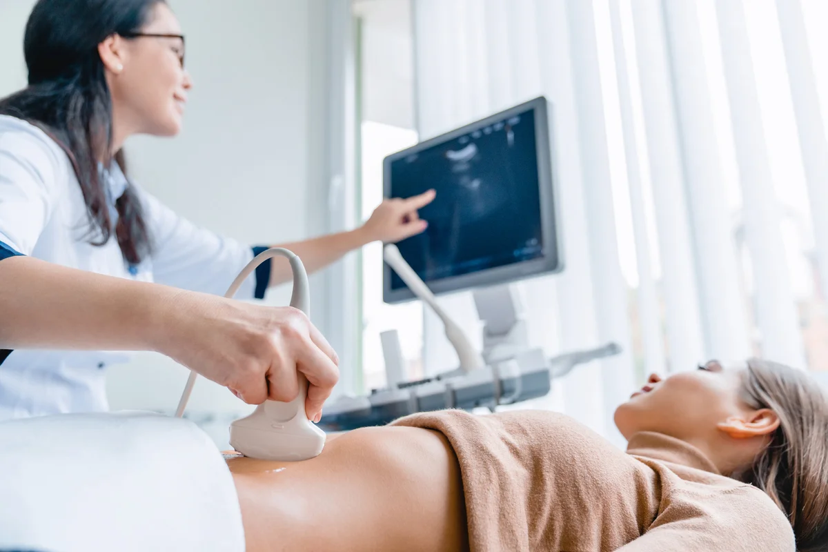 Doctor using ultrasound scanner on a pregnant woman