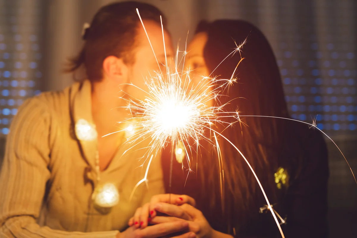 Happy, loving couple celebrating New Year at home