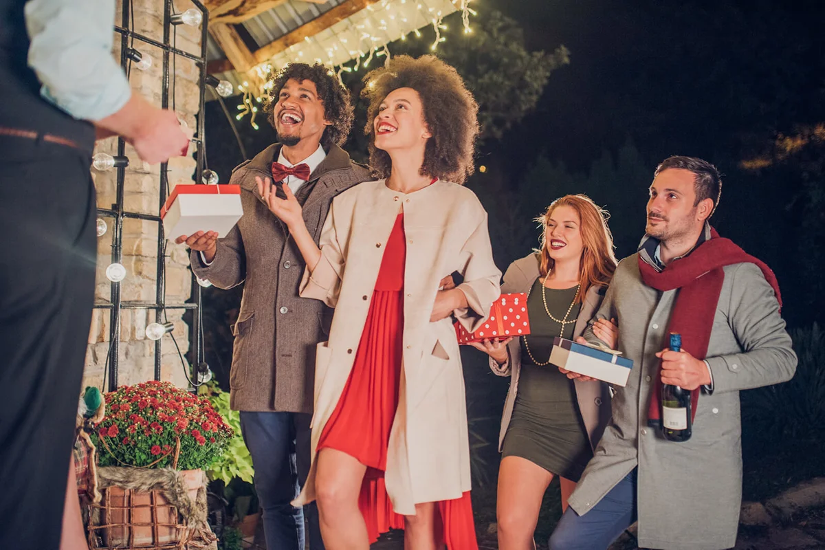 People with Christmas presents and a wine bottle