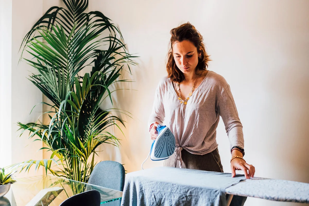 Woman ironing at home