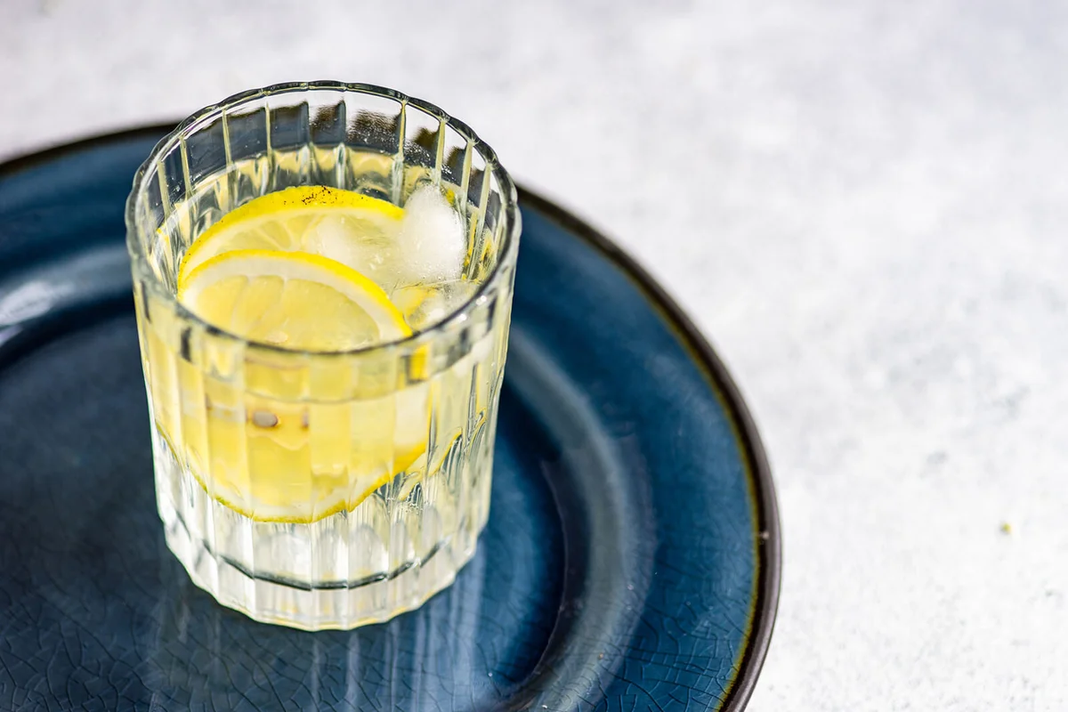Glass of clarified milk punch with oleo saccharum