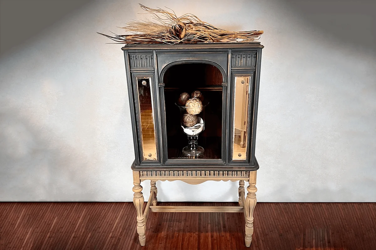 Antique radio cabinet repurposed into display shelf