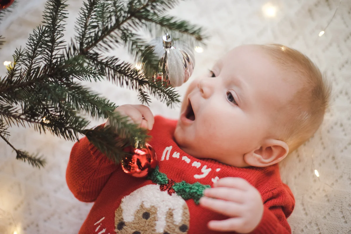 Cute baby under Christmas tree