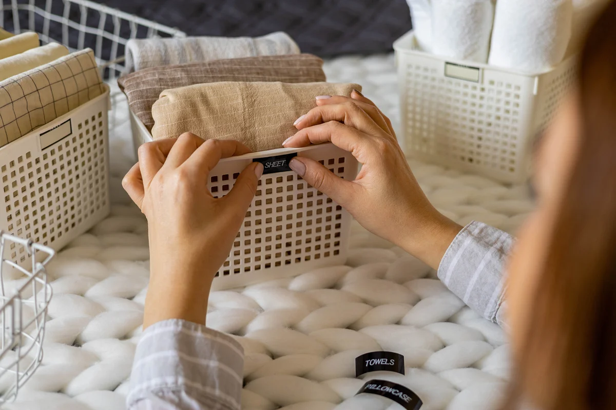 Cropped Hands Of Woman Putting Stickers On Sheet Container