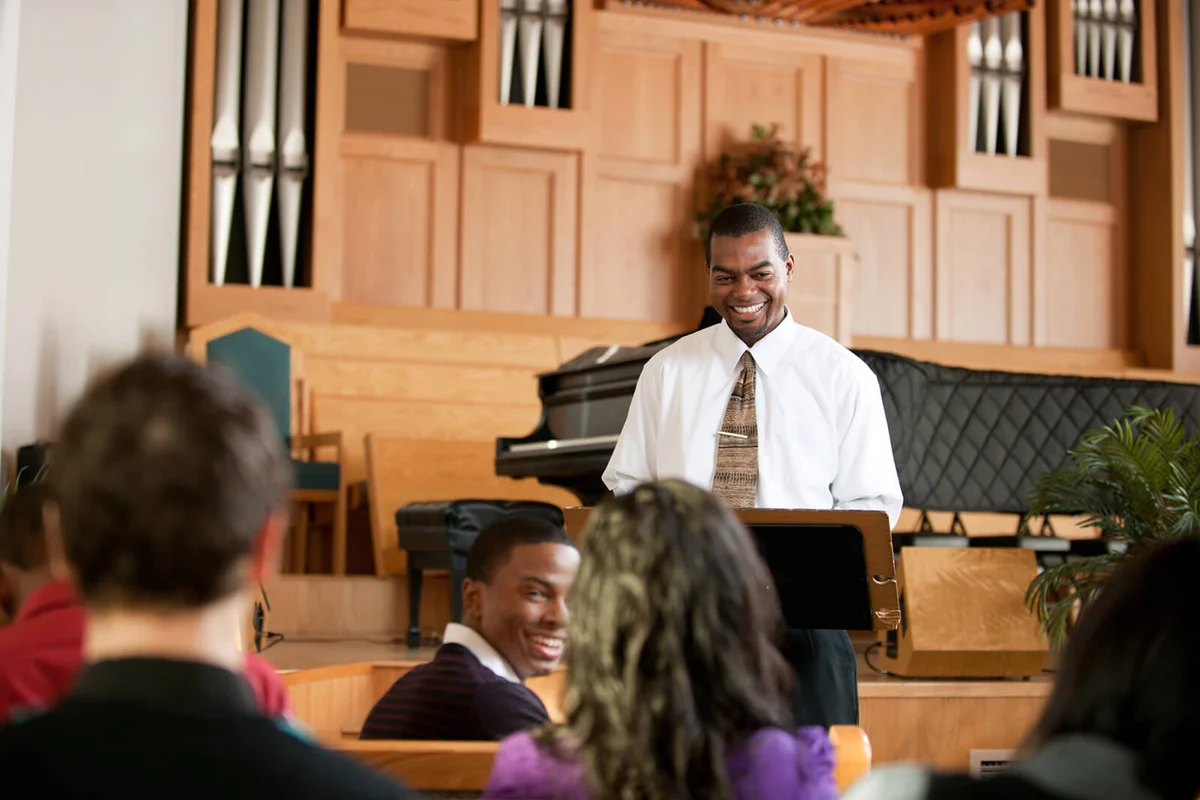 A group of people listening to a sermon in church