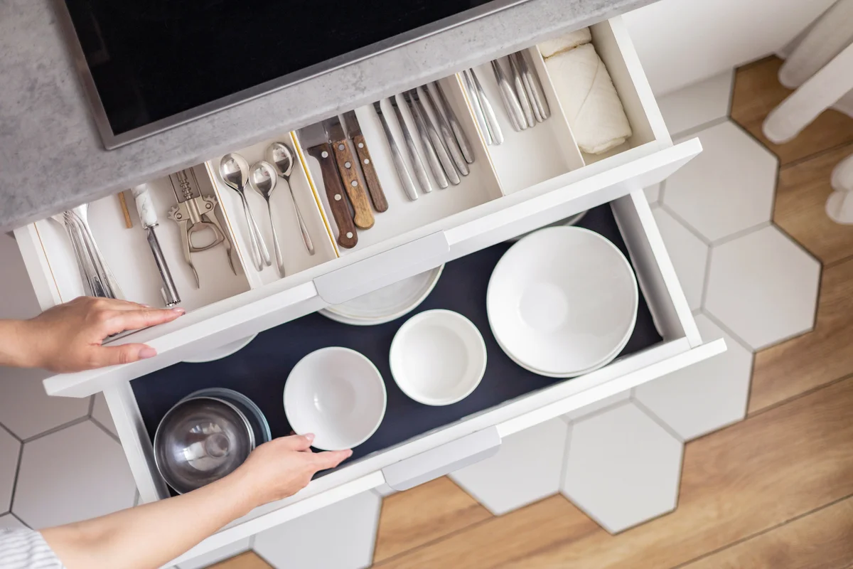 Woman organizing kitchen drawers