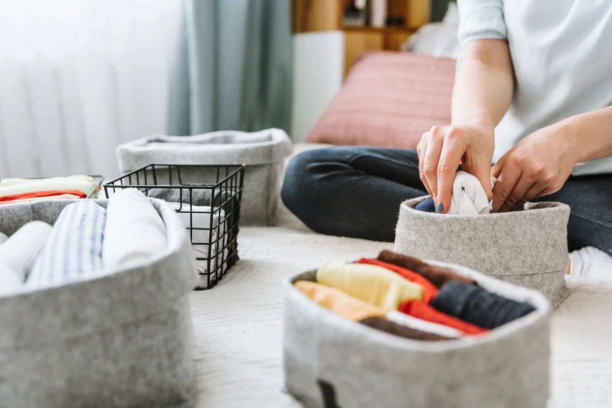 Woman organizing clothes in boxes